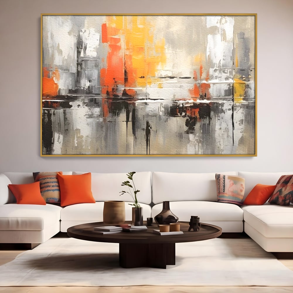 Tablou canvas cu pictura abstracta cu turnuri portocalii, in rama de aluminiu auriu, pe perete intr-un living