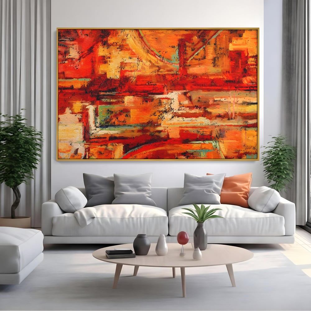 Tablou canvas cu pictura abstracta cu texturi in tonuri de rosu, in rama de aluminiu auriu, pe perete intr-un living