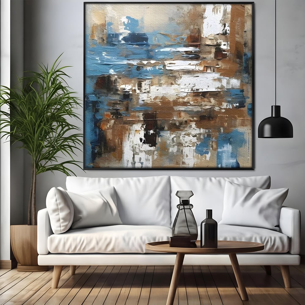 Tablou canvas cu pictura abstracta cu texturi de albastru si maro, in rama de aluminiu negru, pe perete intr-un living