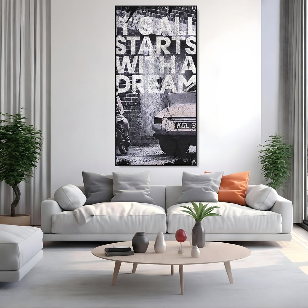 Tablou canvas cu tablou motivational alb-negru cu text si masina, in rama de aluminiu negru, pe perete intr-un living