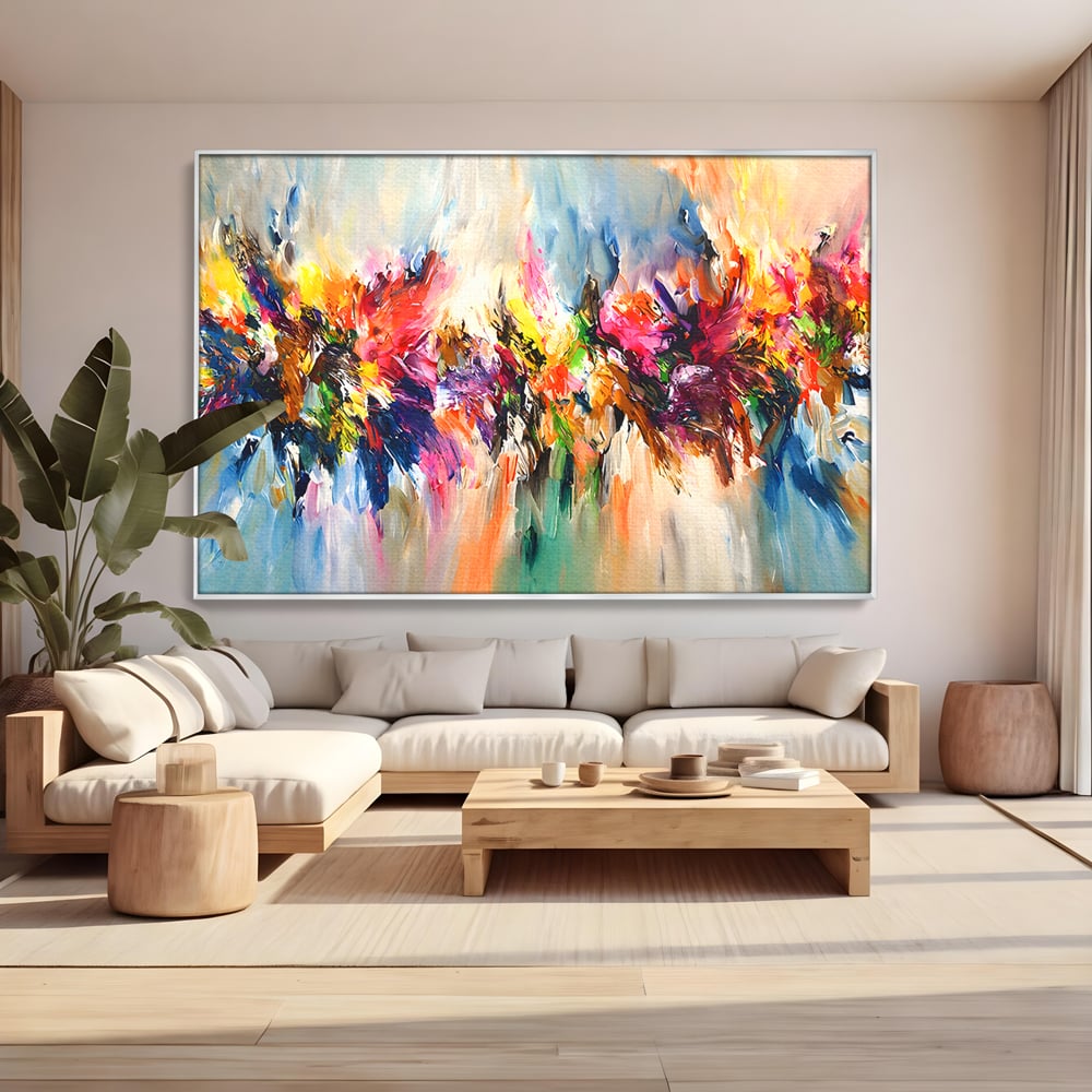 Tablou canvas cu pictura abstracta cu explozie de culoare, in rama de aluminiu argintiu, pe perete intr-un living