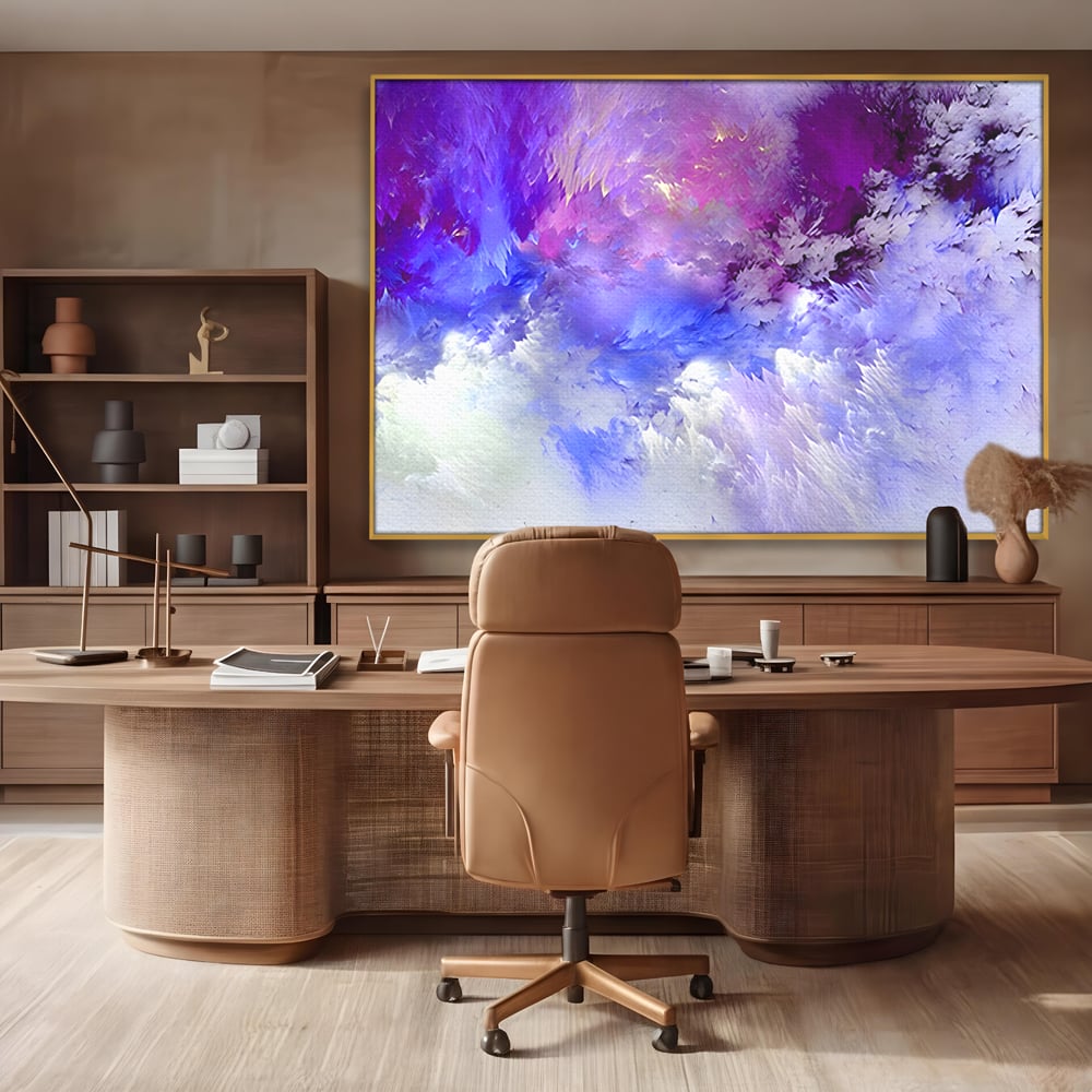 Tablou canvas cu pictura abstracta cu nori mov si albastri, in rama de aluminiu auriu, pe perete intr-un birou