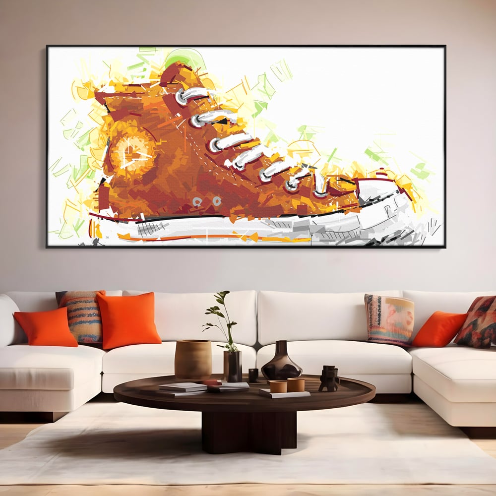 Tablou canvas cu tablou canvas cu tenisi portocalii, in rama de aluminiu negru, pe perete intr-un living