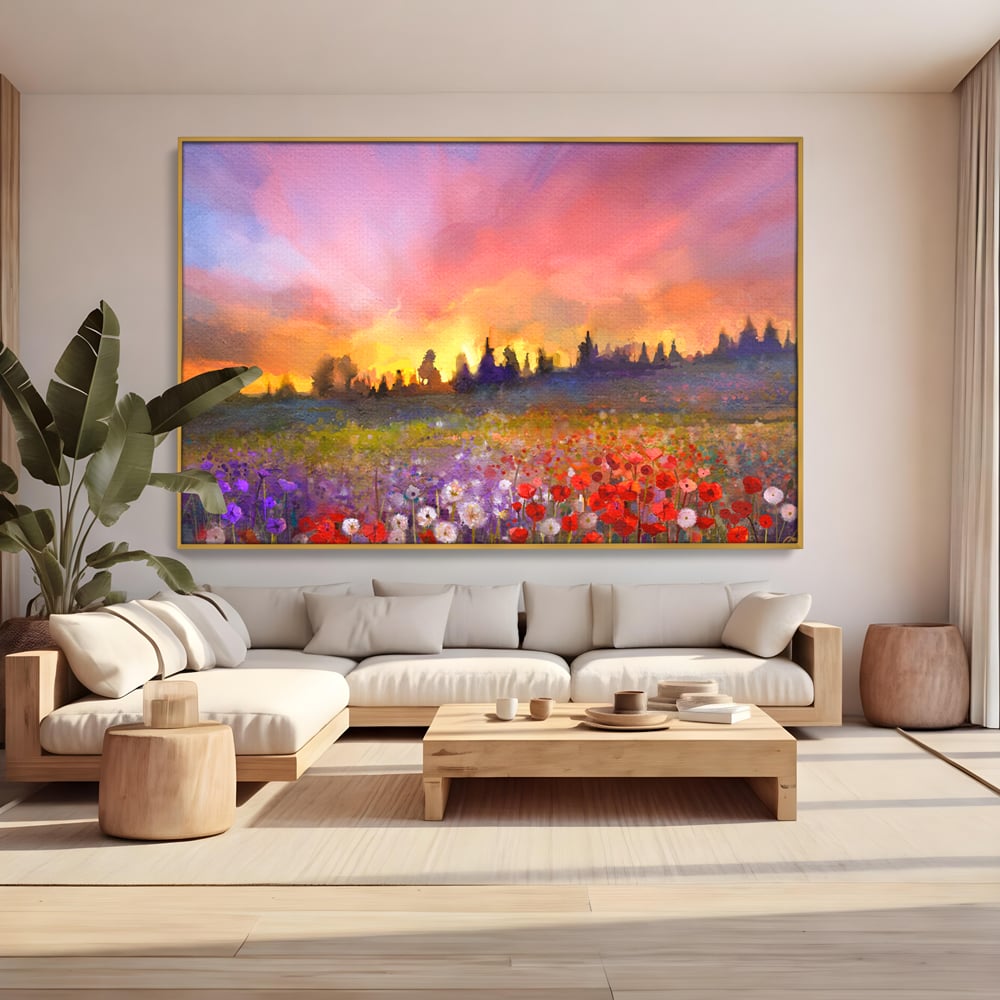 Tablou canvas cu tablou canvas cu camp cu flori si apus, in rama de aluminiu auriu, pe perete intr-un living