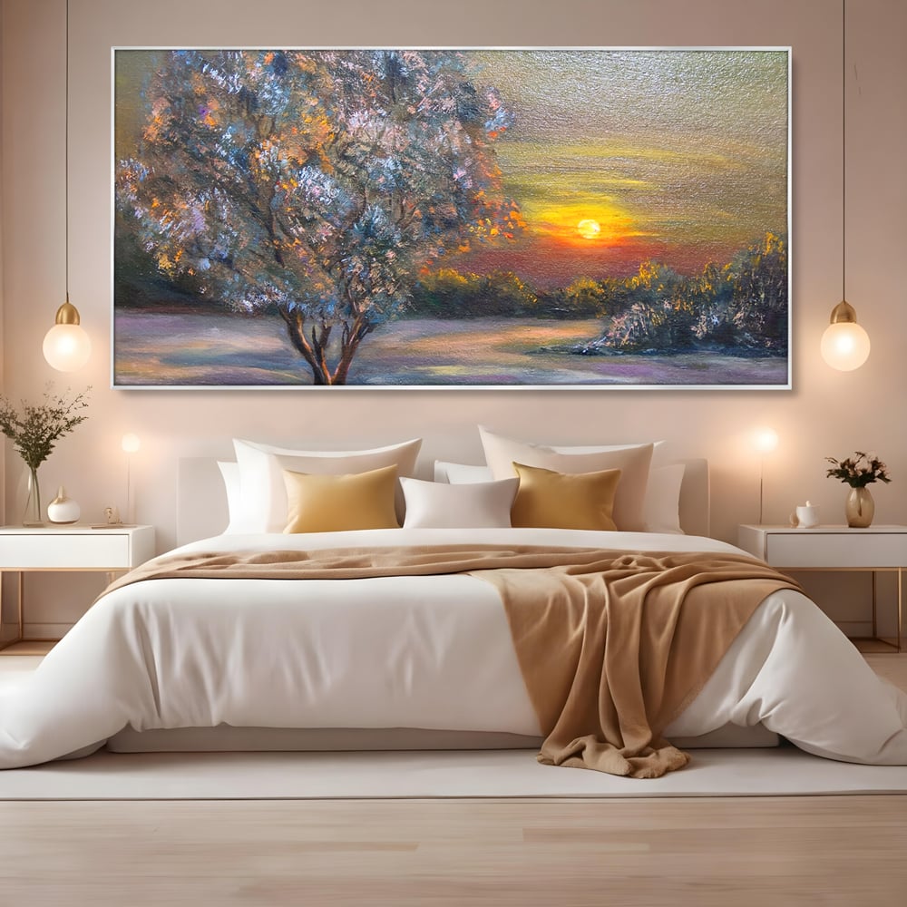 Tablou canvas cu pictura peisaj cu copac si apus, in rama de aluminiu argintiu, pe perete intr-un dormitor