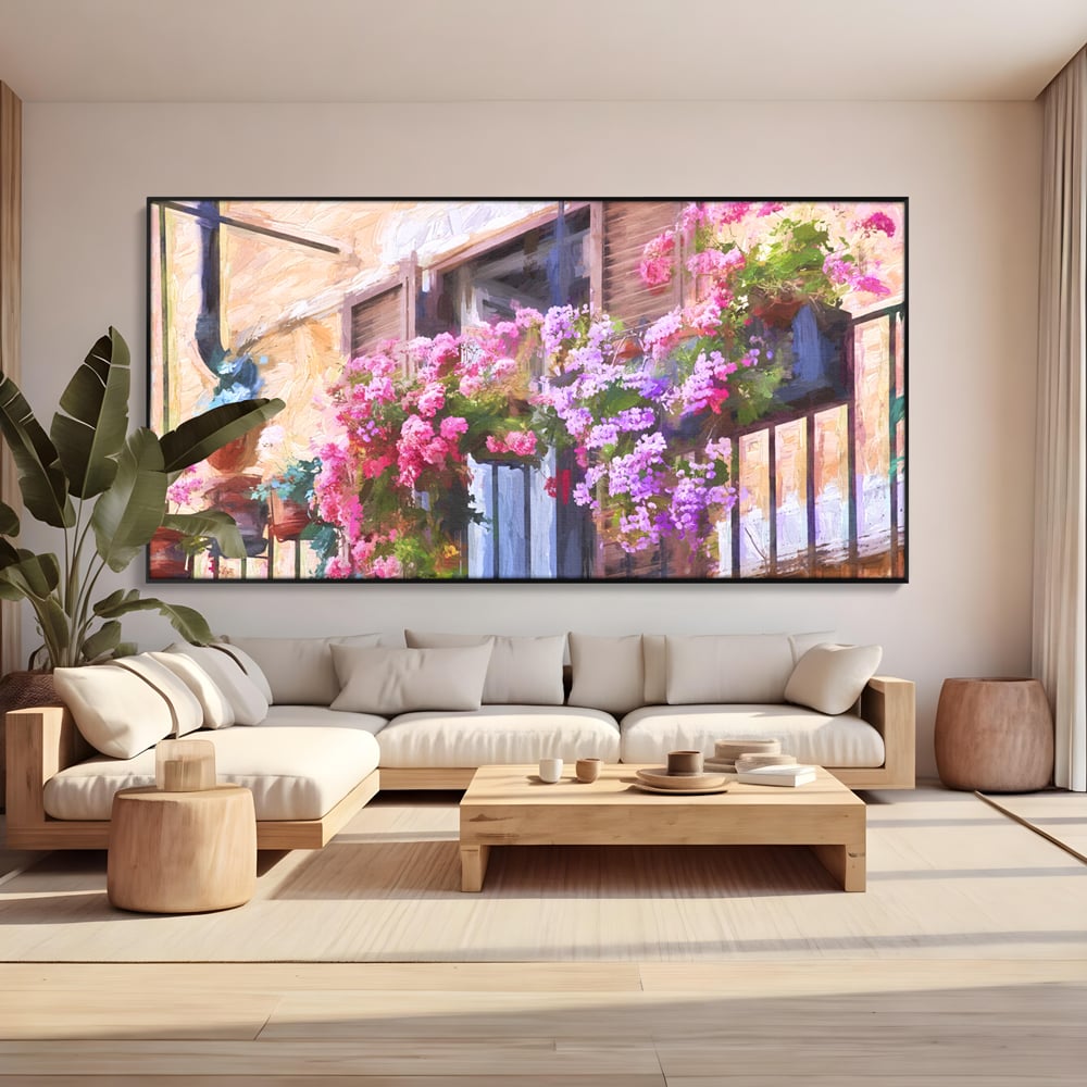 Tablou canvas cu pictura cu balcon plin de flori roz, in rama de aluminiu negru, pe perete intr-un living