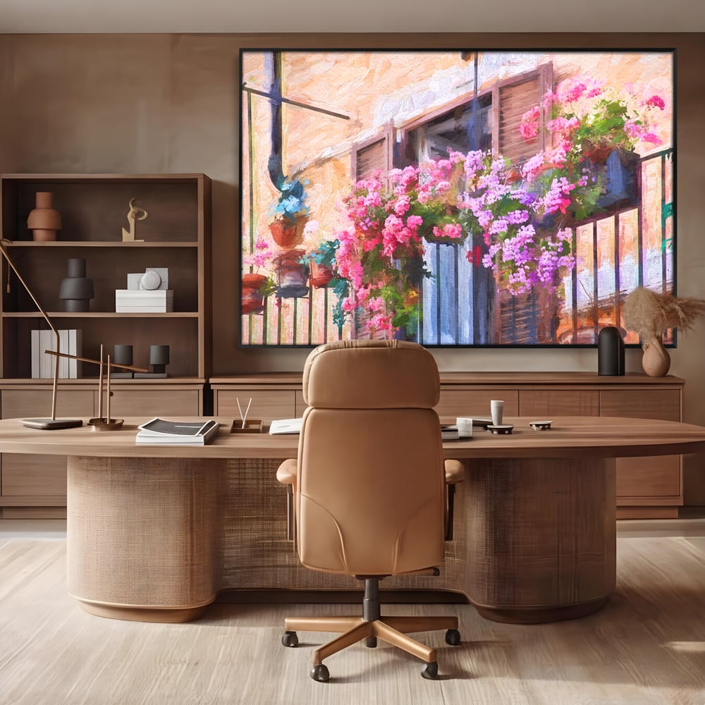 Tablou canvas cu pictura cu balcon plin de flori roz, in rama de aluminiu negru, pe perete intr-un birou