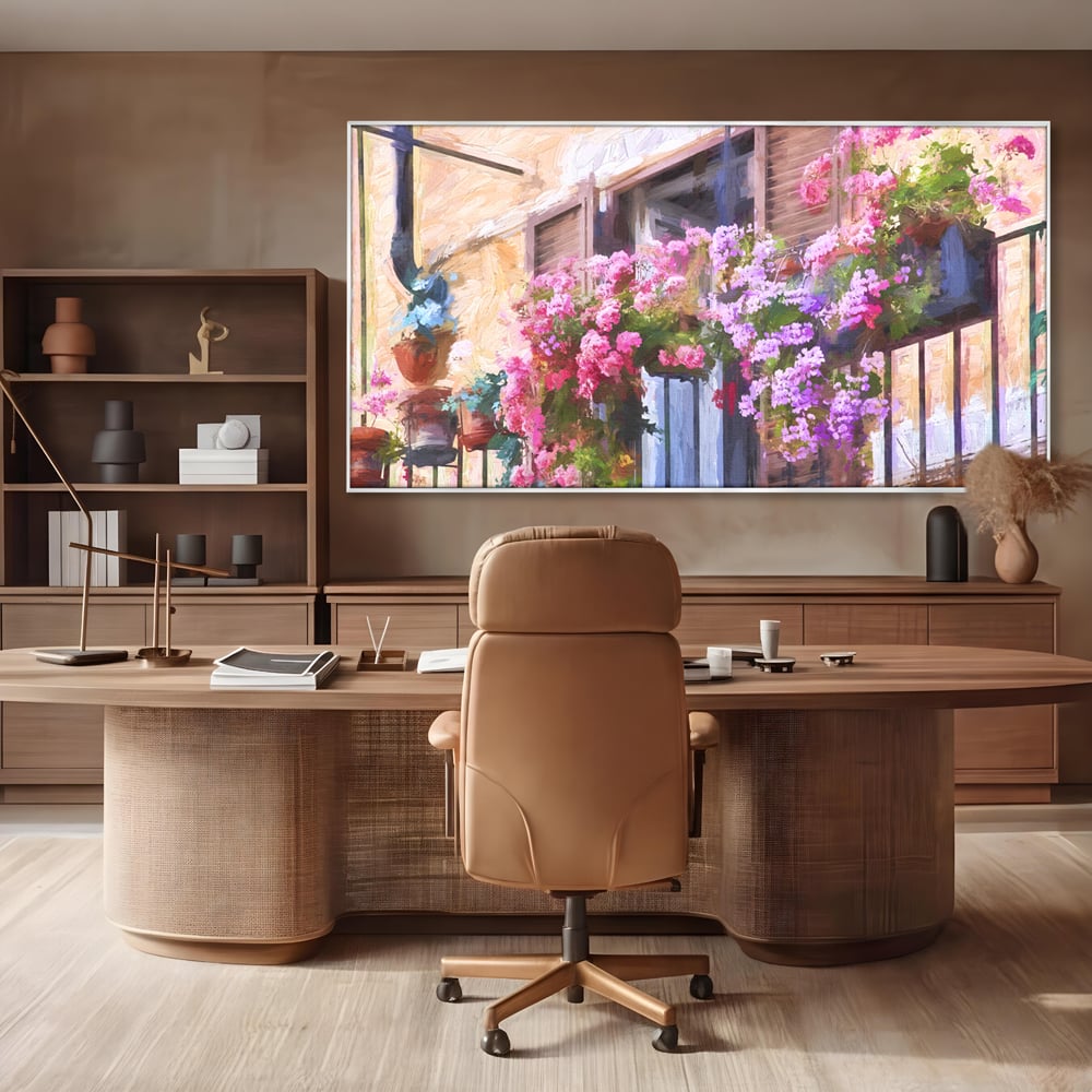 Tablou canvas cu pictura cu balcon plin de flori roz, in rama de aluminiu argintiu, pe perete intr-un birou