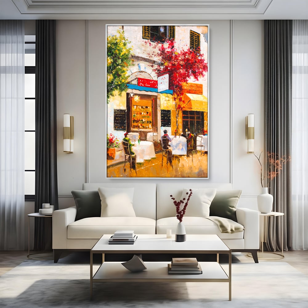 Tablou canvas cu pictura stradala cu terasa, in rama de aluminiu argintiu, pe perete intr-un living