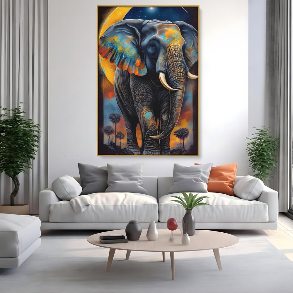 Tablou canvas cu tablou canvas cu elefant colorat si luna, in rama de aluminiu auriu, pe perete intr-un living