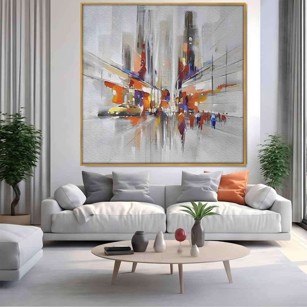 Tablou canvas cu pictura abstracta cu peisaj urban, in rama de aluminiu auriu, pe perete intr-un living