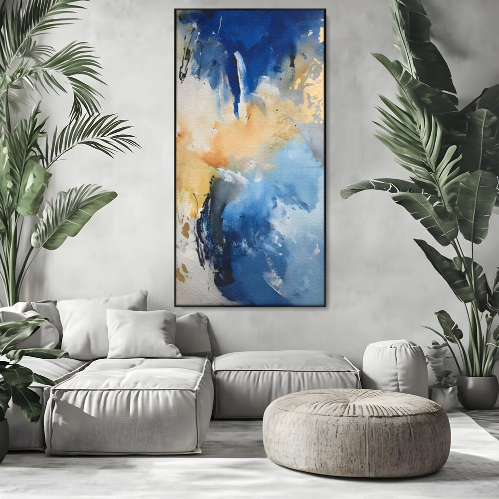 Tablou canvas cu pictura abstracta cu pete albastre si aurii, in rama de aluminiu negru, pe perete intr-un living