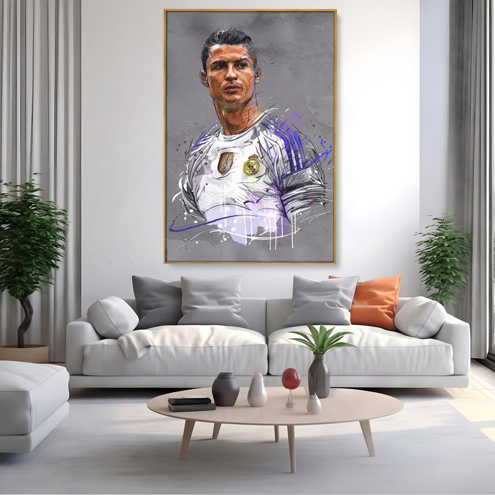 Tablou canvas cu tablou canvas cu cristiano ronaldo in tricoul real madrid, in rama de aluminiu auriu, pe perete intr-un living