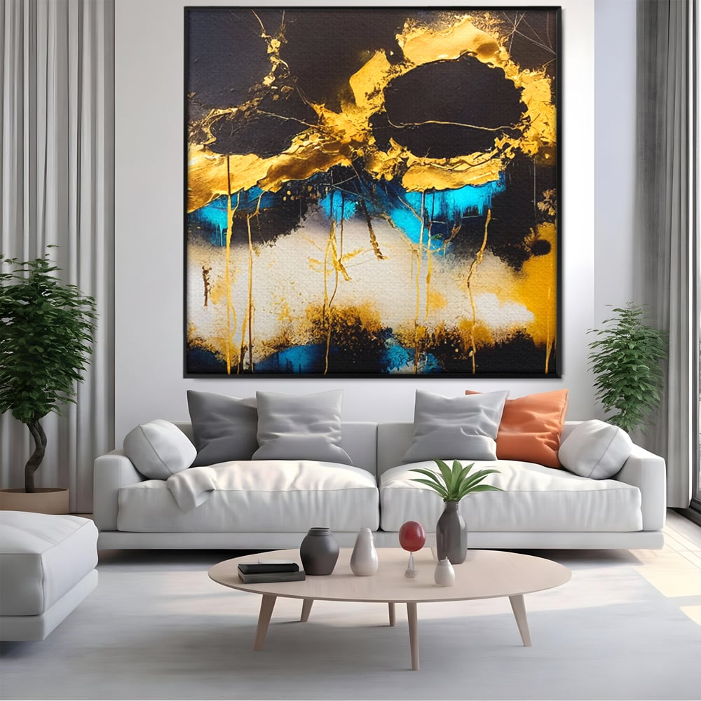 Tablou canvas cu pictura abstracta cu forme aurii si albastre, in rama de aluminiu negru, pe perete intr-un living