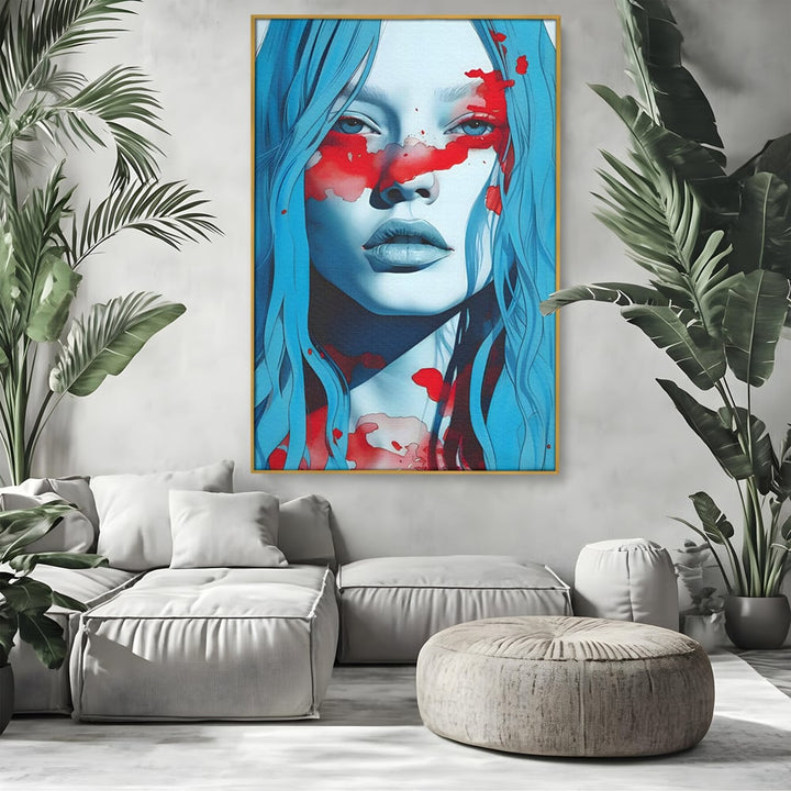 Tablou canvas cu tablou canvas cu portret albastru si pete rosii, in rama de aluminiu auriu, pe perete intr-un living