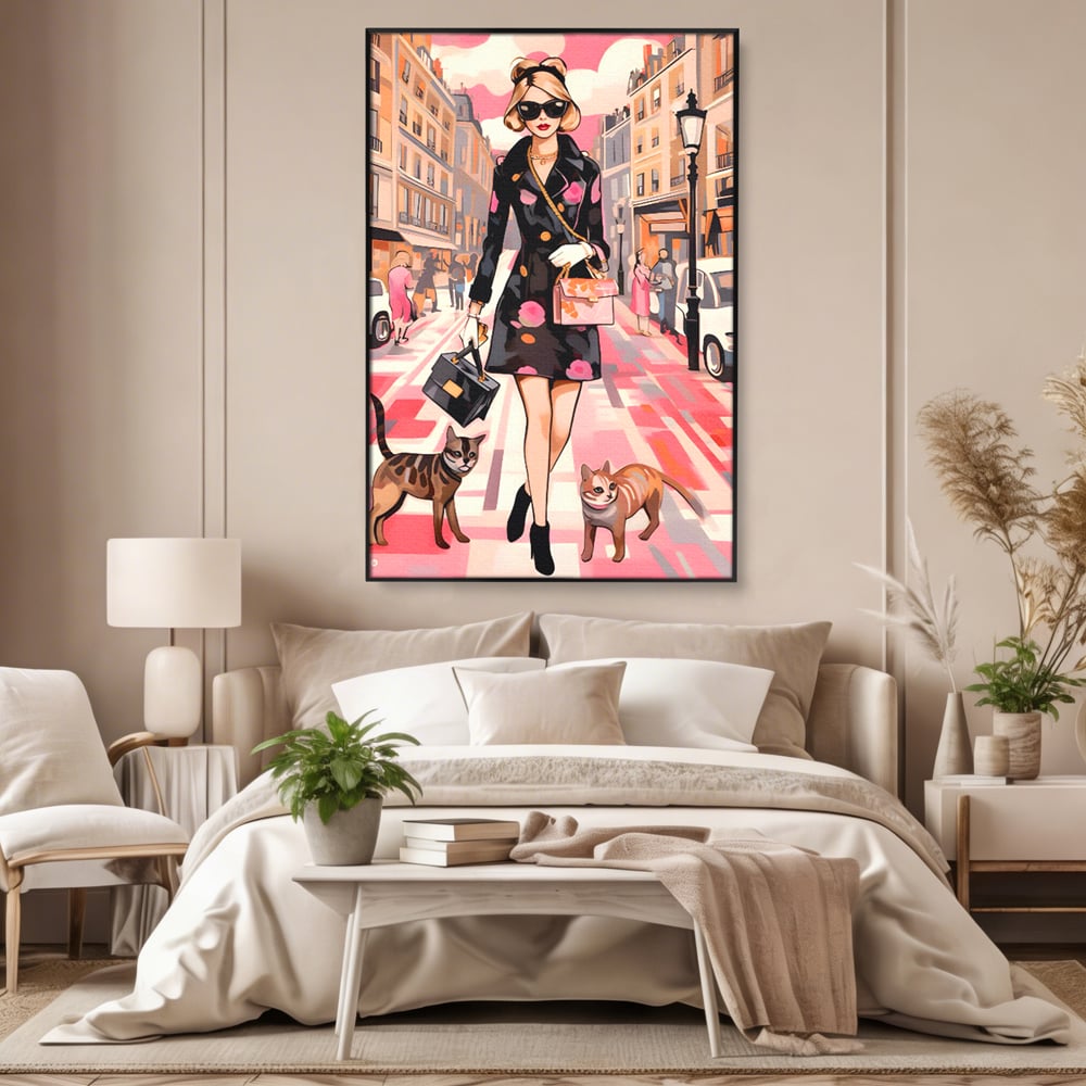 Tablou canvas cu ilustratie fashion cu femeie si pisici, in rama de aluminiu negru, pe perete intr-un dormitor
