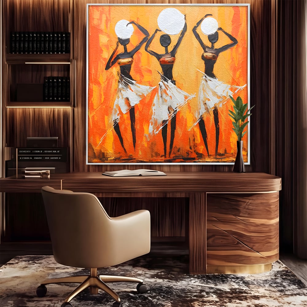 Tablou canvas cu tablou canvas cu trei dansatoare africane, in rama de aluminiu argintiu, pe perete intr-un birou