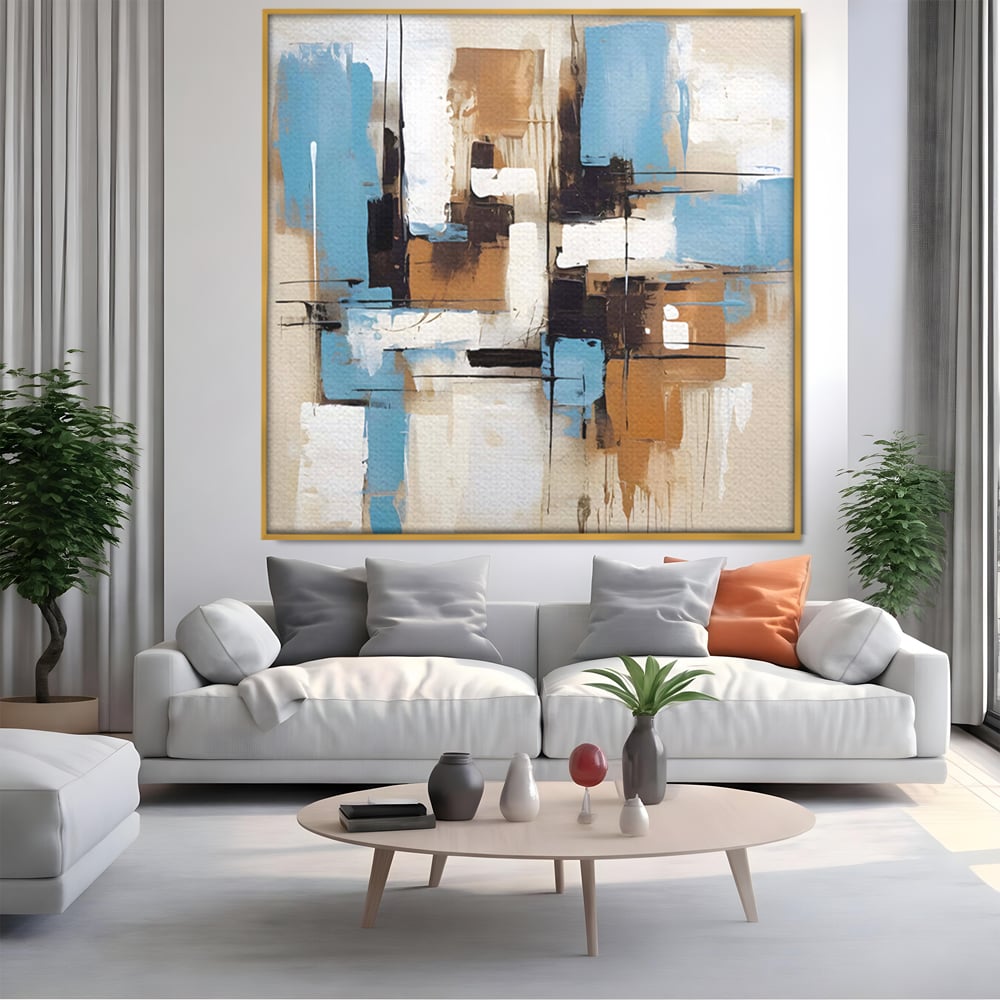 Tablou canvas cu pictura abstracta cu forme geometrice albastre, in rama de aluminiu auriu, pe perete intr-un living