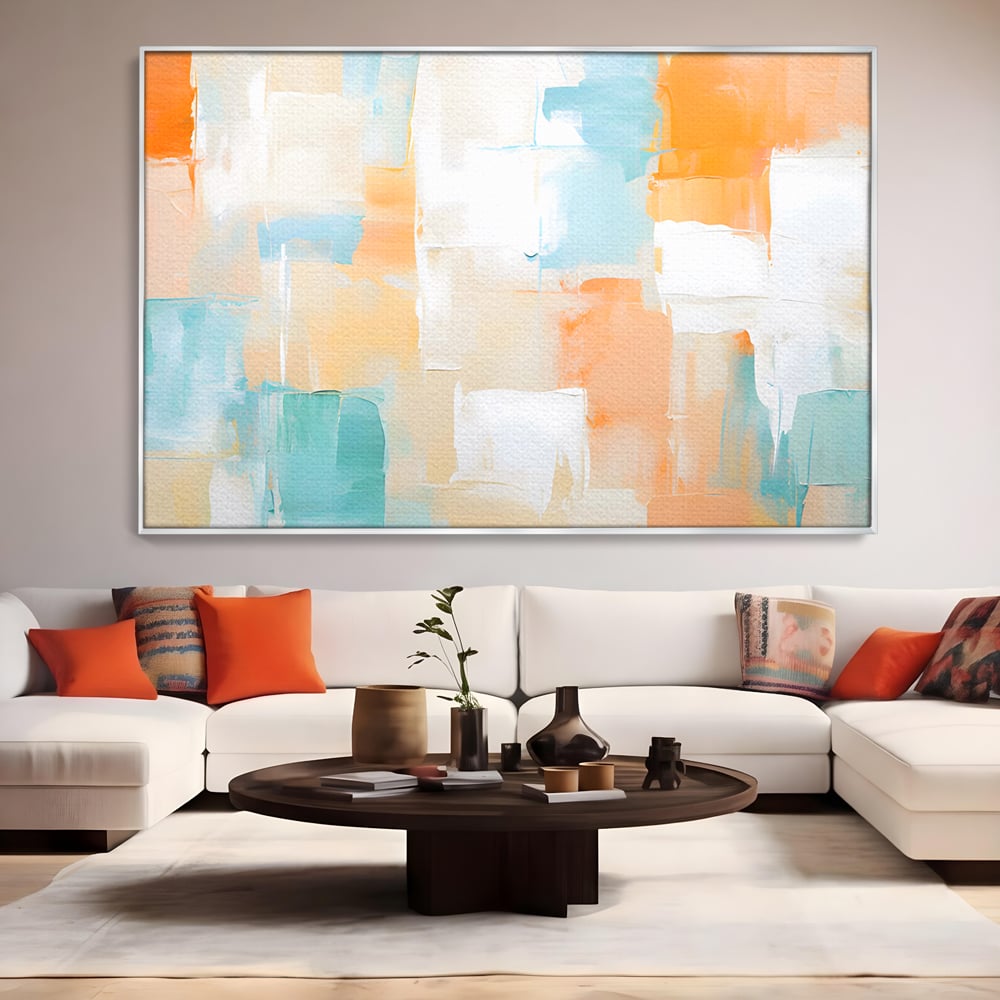 Tablou canvas cu pictura abstracta cu pete colorate, in rama de aluminiu argintiu, pe perete intr-un living