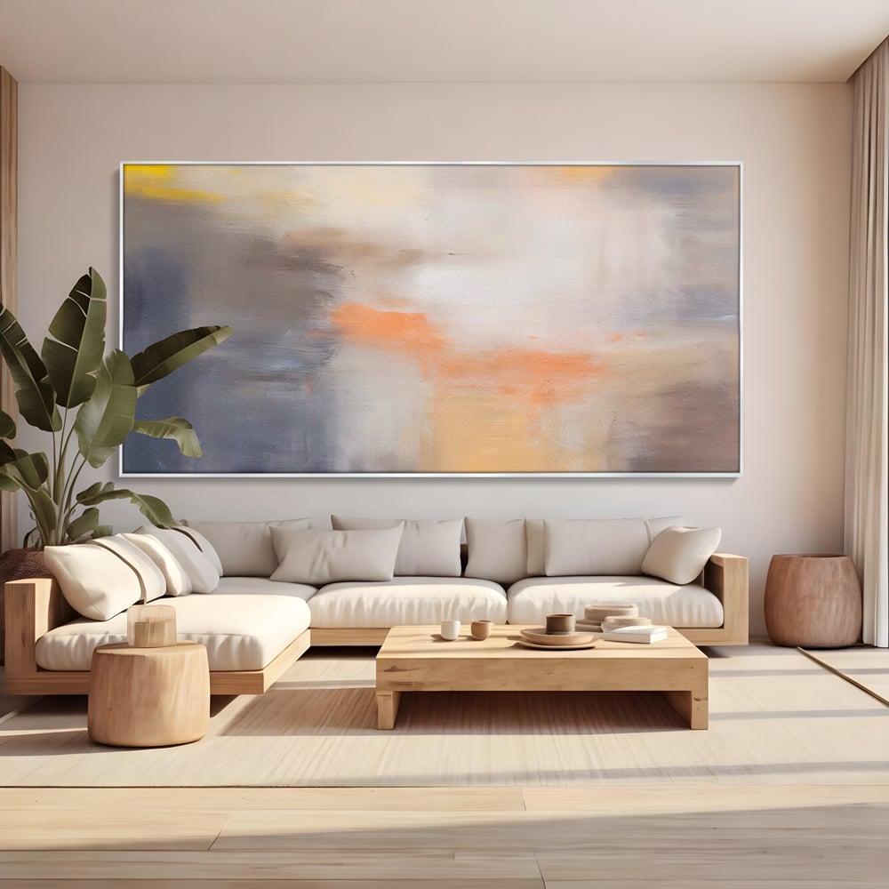 Tablou canvas cu pictura abstracta cu pete portocalii, in rama de aluminiu argintiu, pe perete intr-un living