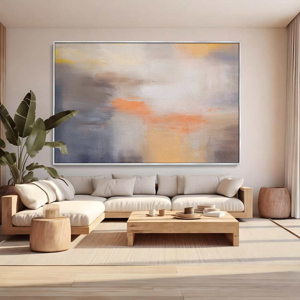 Tablou canvas cu pictura abstracta cu pete portocalii, in rama de aluminiu argintiu, pe perete intr-un living
