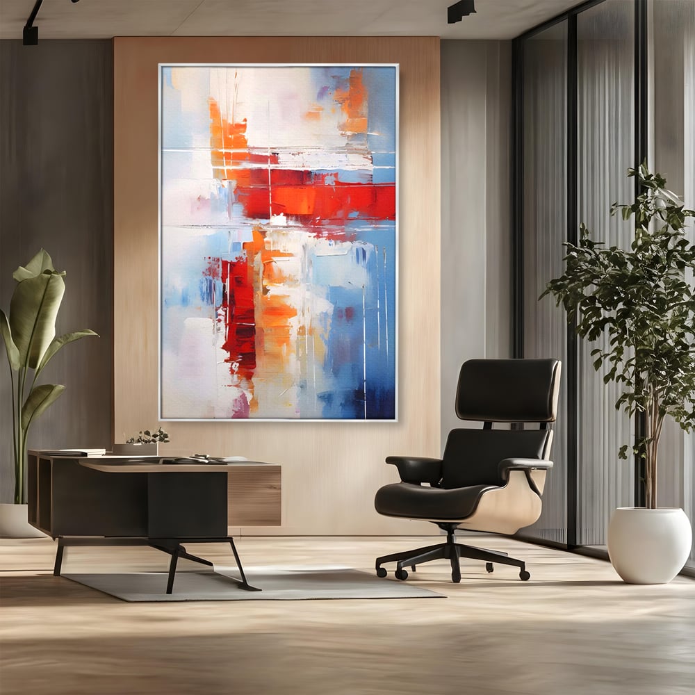 Tablou canvas cu pictura abstracta cu rosu si albastru, in rama de aluminiu argintiu, pe perete intr-un birou