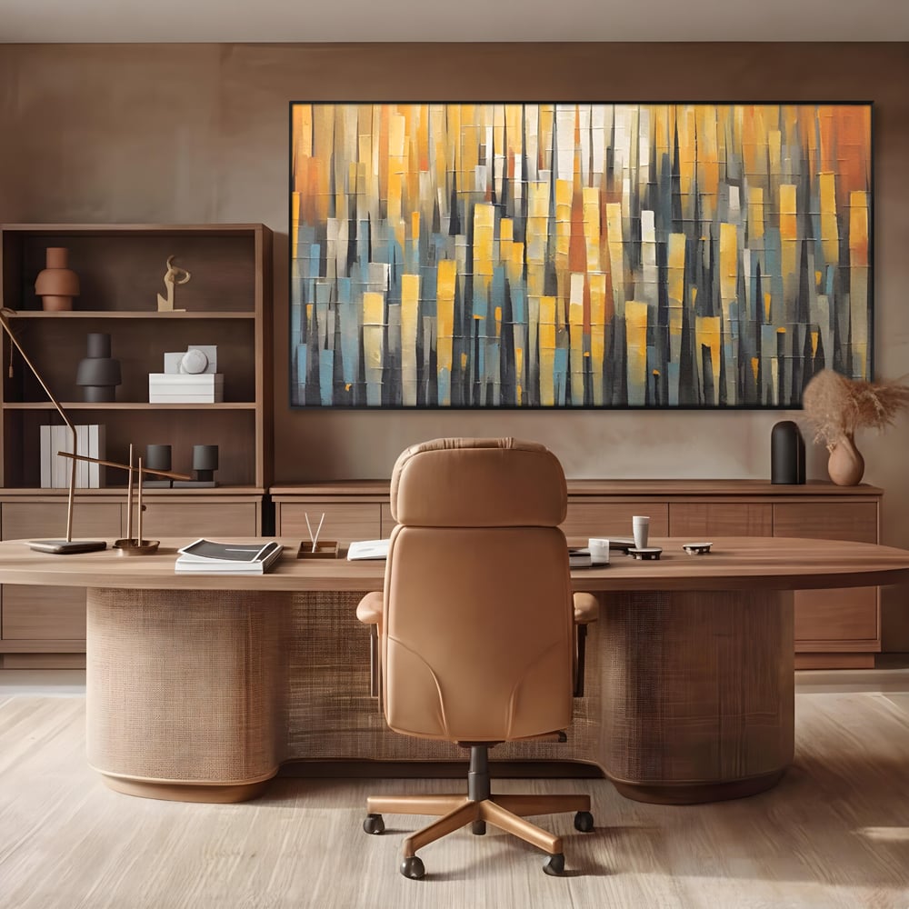Tablou canvas cu pictura abstracta cu dungi verticale aurii, in rama de aluminiu negru, pe perete intr-un birou