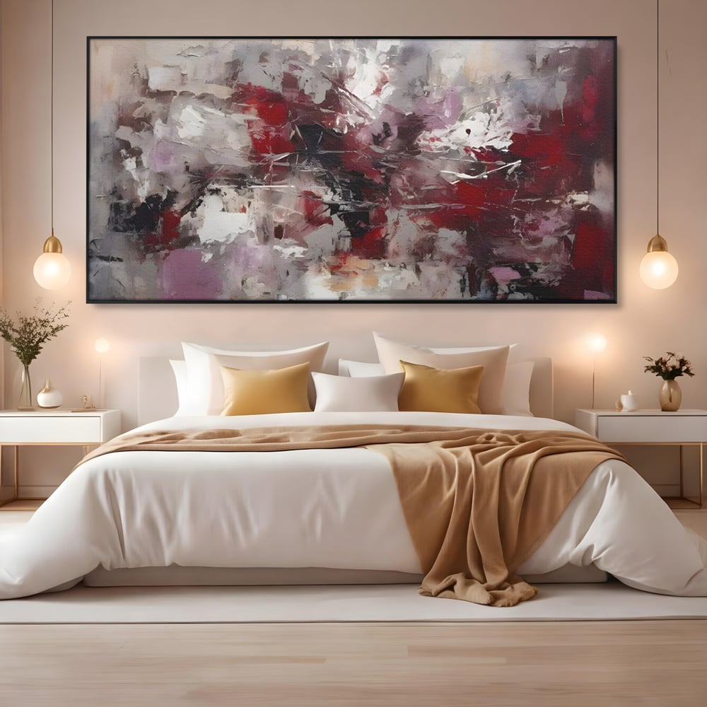 Tablou canvas cu pictura abstracta cu pete rosii, in rama de aluminiu negru, pe perete intr-un dormitor