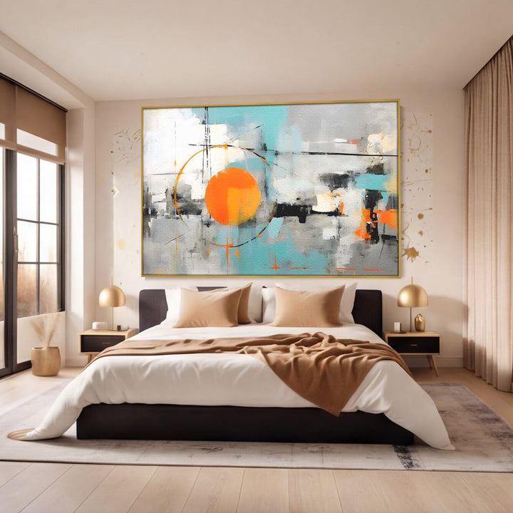 Tablou canvas cu pictura abstracta cu cerc portocaliu, in rama de aluminiu auriu, pe perete intr-un dormitor