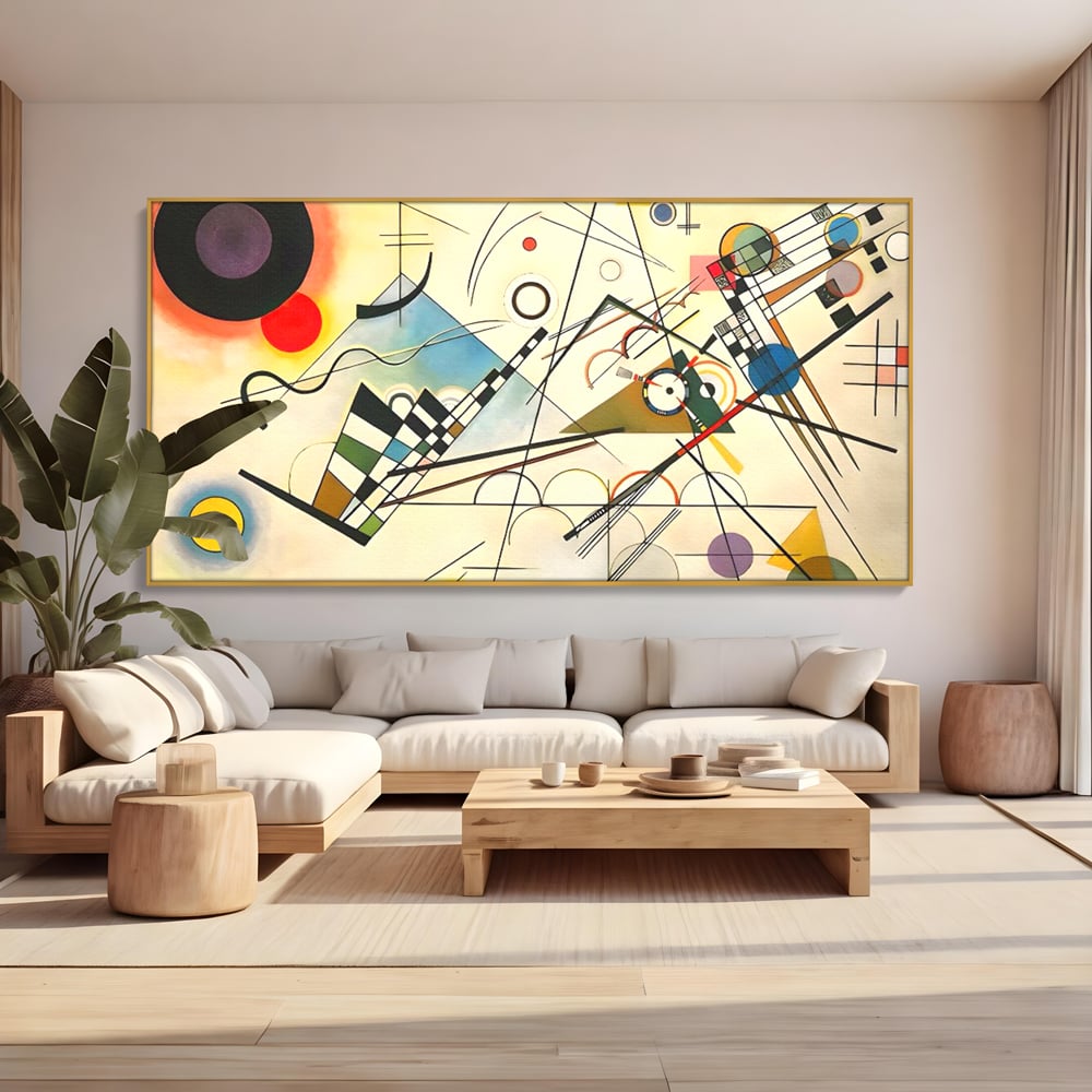 Tablou canvas cu pictura abstracta cu forme geometrice colorate, in rama de aluminiu auriu, pe perete intr-un living