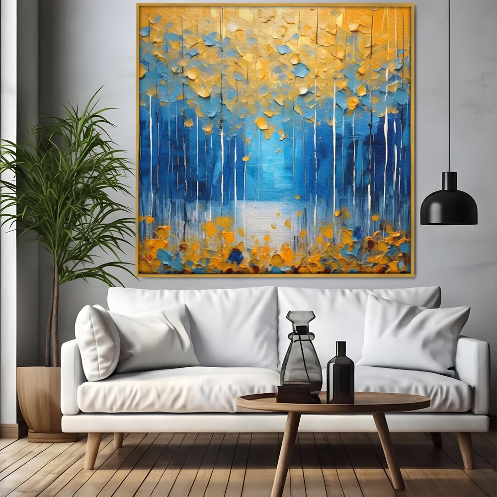 Tablou canvas cu pictura abstracta cu frunze si copaci, in rama de aluminiu auriu, pe perete intr-un living