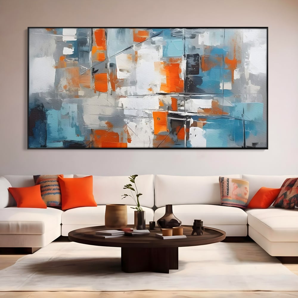 Tablou canvas cu pictura abstracta cu blocuri portocalii si albastre, in rama de aluminiu negru, pe perete intr-un living