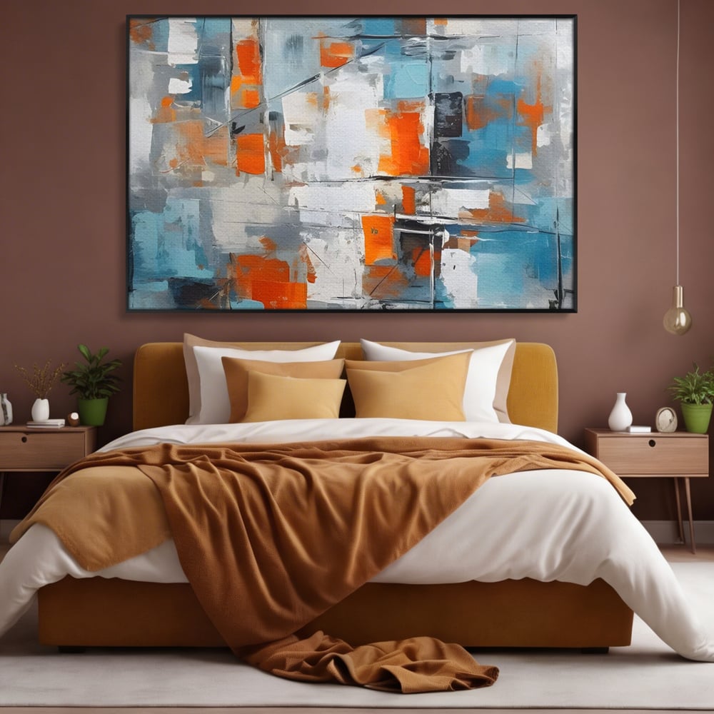 Tablou canvas cu pictura abstracta cu blocuri portocalii si albastre, in rama de aluminiu negru, pe perete intr-un dormitor