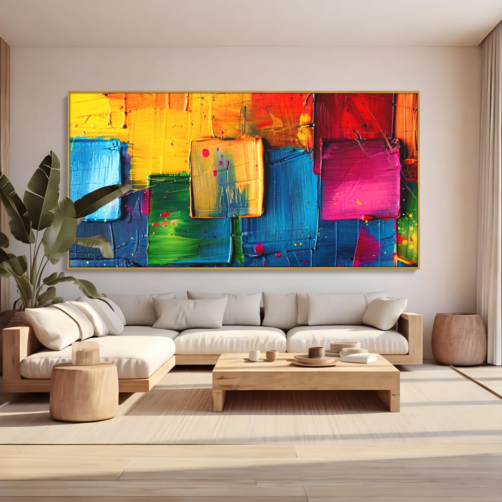 Tablou canvas cu pictura abstracta cu patrate colorate in relief, in rama de aluminiu auriu, pe perete intr-un living