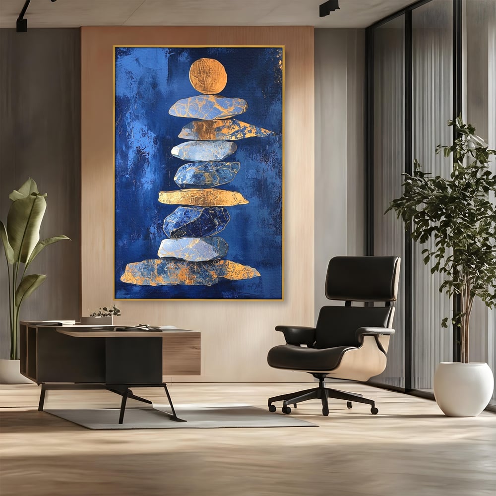 Tablou canvas cu tablou canvas cu stive de pietre si cerc auriu, in rama de aluminiu auriu, pe perete intr-un birou