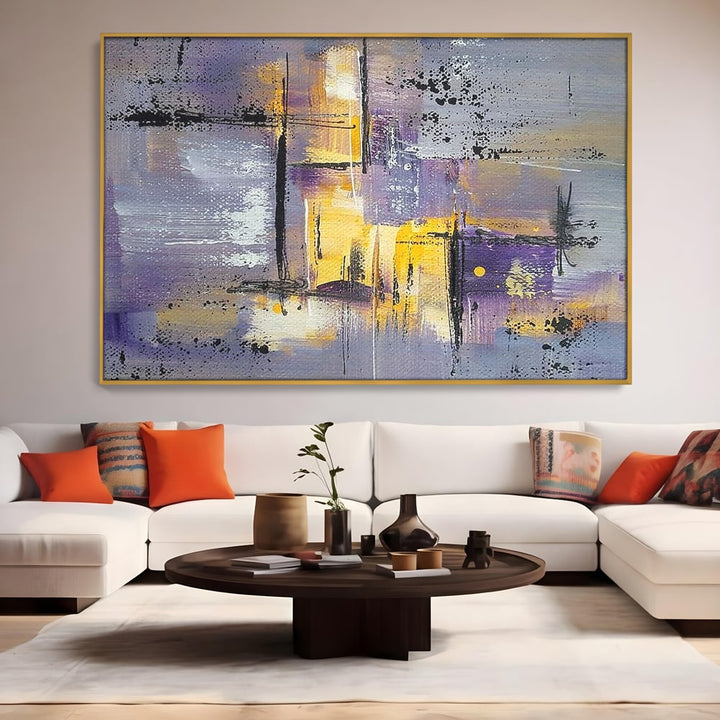 Tablou canvas cu pictura abstracta cu linii si pete, in rama de aluminiu auriu, pe perete intr-un living