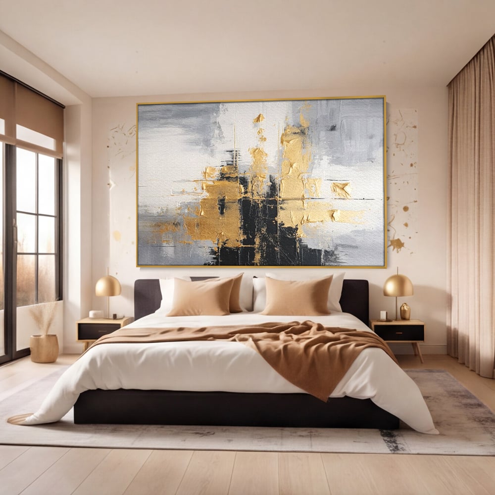 Tablou canvas cu pictura abstracta cu auriu si negru, in rama de aluminiu auriu, pe perete intr-un dormitor