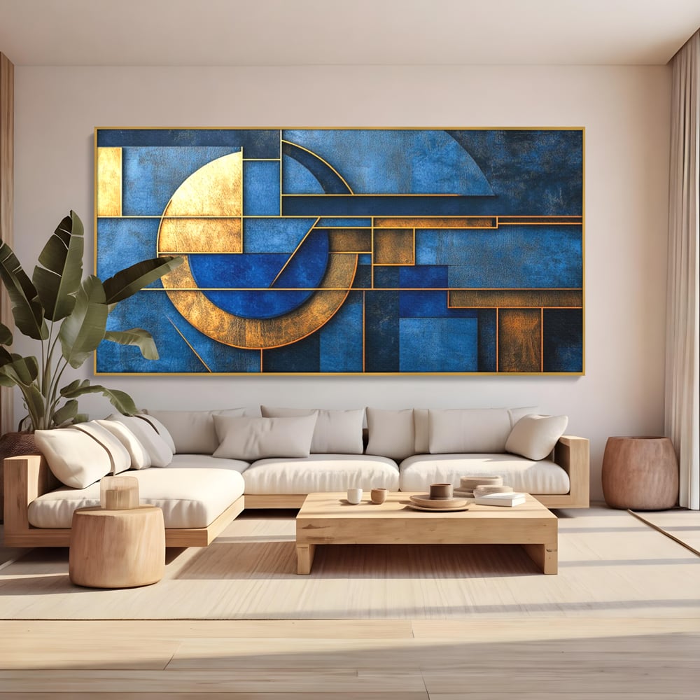 Tablou canvas cu tablou canvas cu forme geometrice albastre si aurii, in rama de aluminiu auriu, pe perete intr-un living