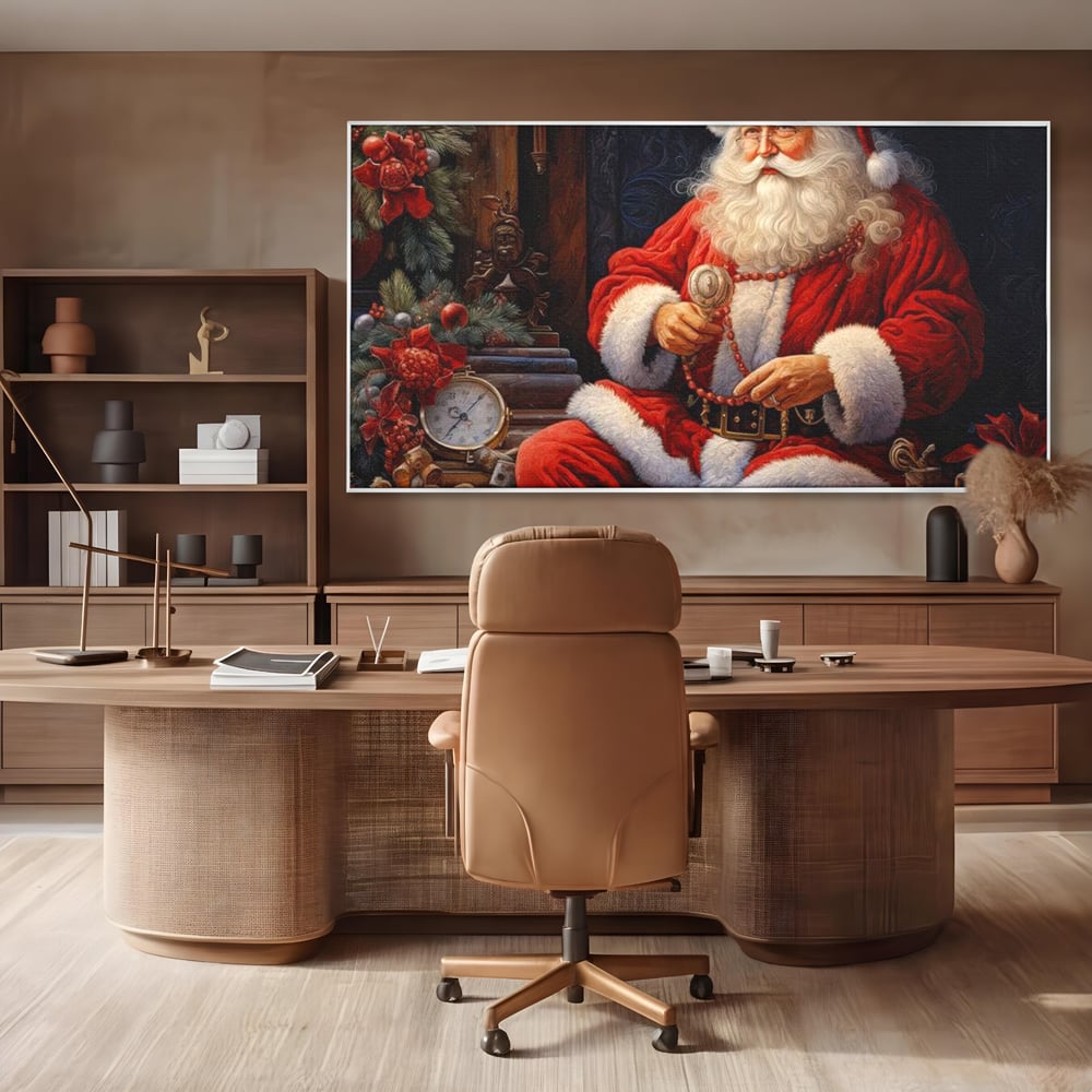 Tablou canvas cu mos craciun cu haina rosie, in rama de aluminiu argintiu, pe perete intr-un birou