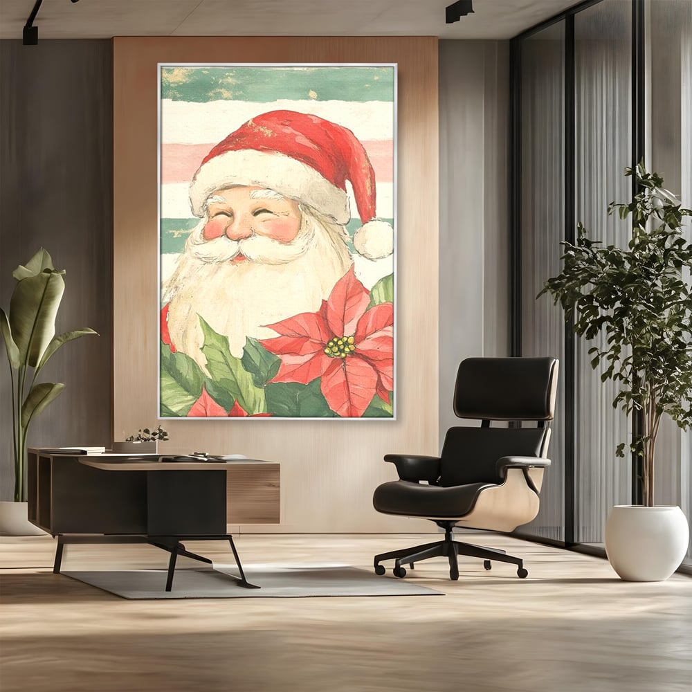 Tablou canvas cu portret ilustrativ cu mos craciun, in rama de aluminiu argintiu, pe perete intr-un birou
