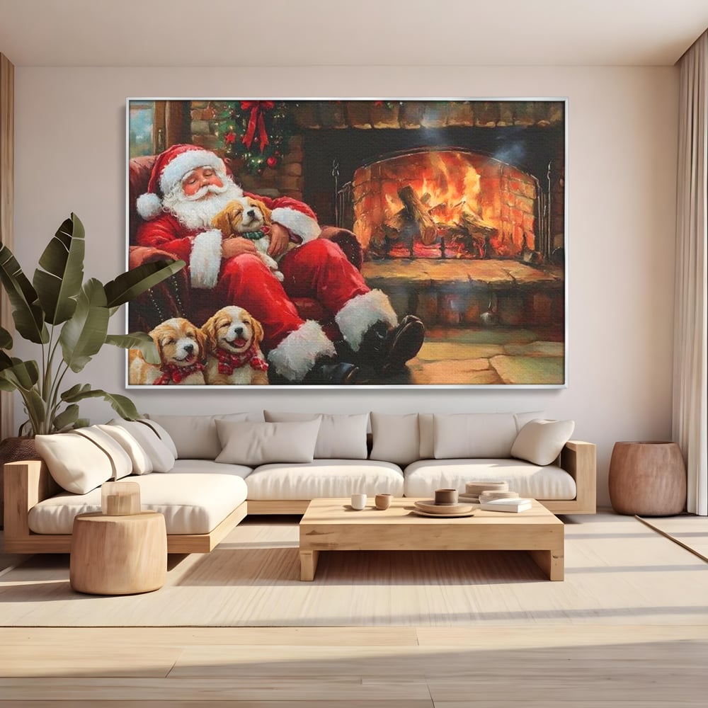 Tablou canvas cu mos craciun dormind cu catei langa semineu, in rama de aluminiu argintiu, pe perete intr-un living