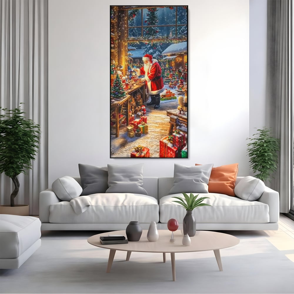 Tablou canvas cu ilustratie digitala cu mos craciun in atelier, in rama de aluminiu negru, pe perete intr-un living