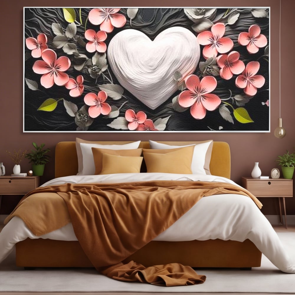 Tablou canvas cu tablou canvas cu inima alba si flori roz, in rama de aluminiu argintiu, pe perete intr-un dormitor