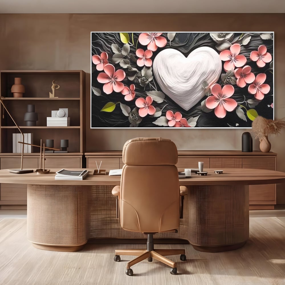 Tablou canvas cu tablou canvas cu inima alba si flori roz, in rama de aluminiu argintiu, pe perete intr-un birou