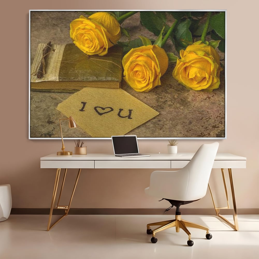 Tablou canvas cu tablou canvas cu trandafiri galbeni si jurnal, in rama de aluminiu argintiu, pe perete intr-un birou