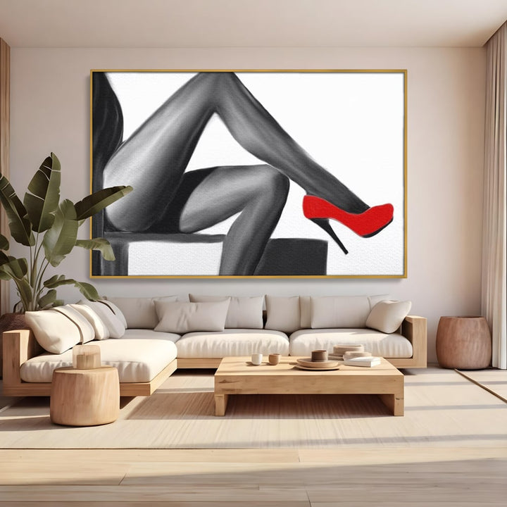 Tablou canvas cu illustratie alb negru cu picioare si pantof rosu, in rama de aluminiu auriu, pe perete intr-un living