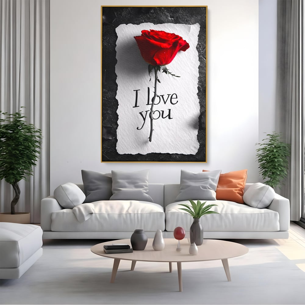 Tablou canvas cu tablou vertical cu trandafir rosu si mesaj, in rama de aluminiu auriu, pe perete intr-un living