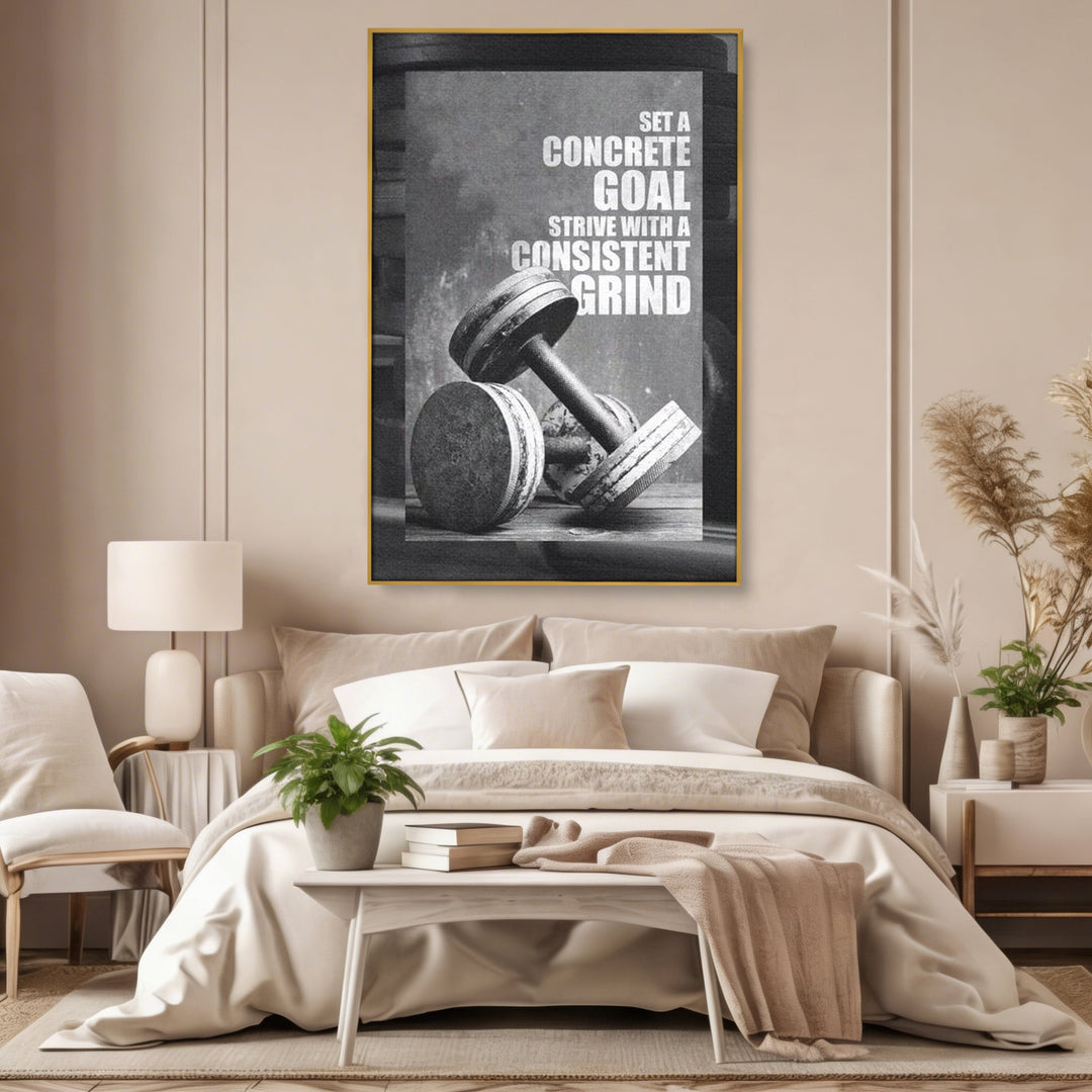 Tablou canvas cu tablou motivational cu gantere si text, in rama de aluminiu auriu, pe perete intr-un dormitor