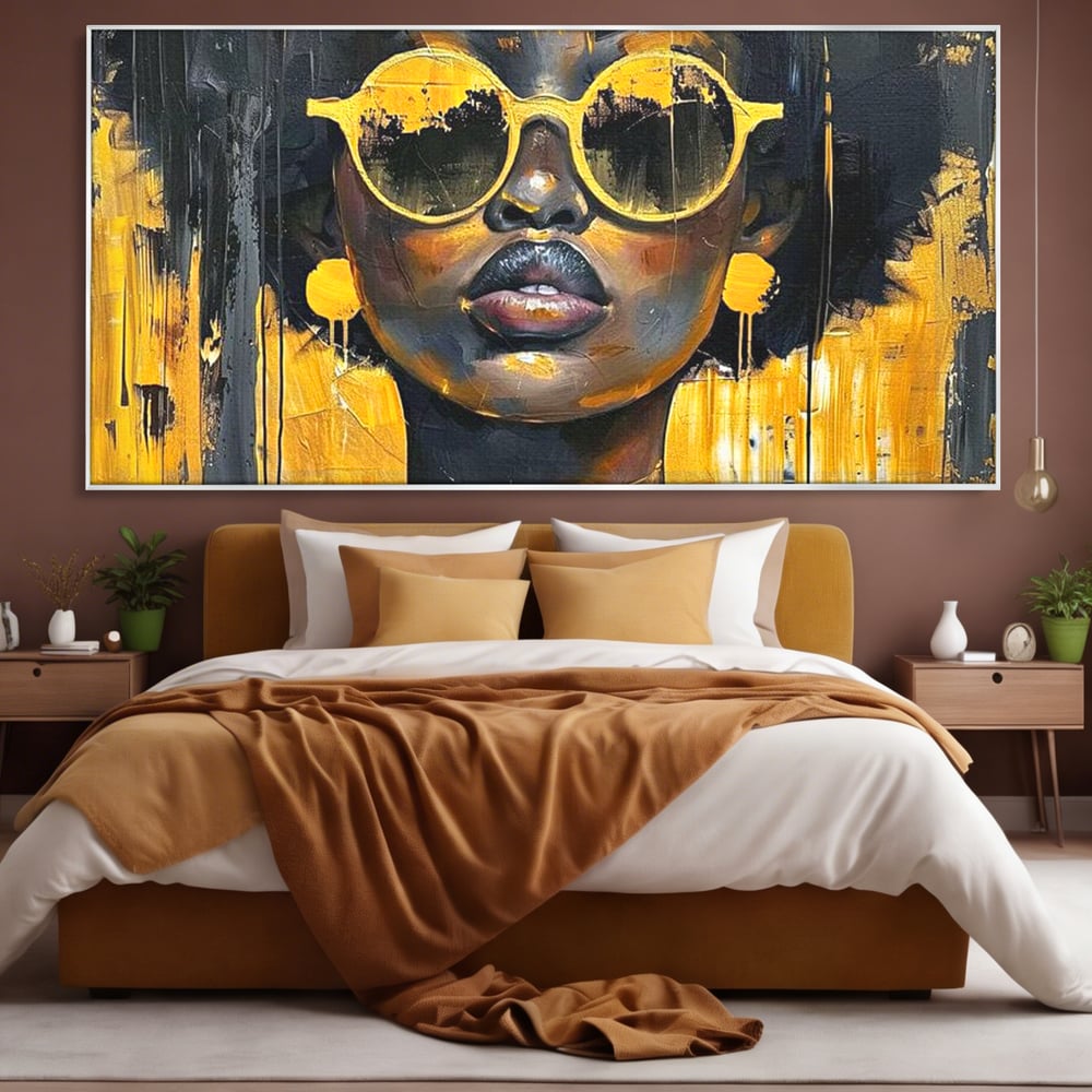 Tablou canvas cu tablou canvas cu femeie afro si ochelari, in rama de aluminiu argintiu, pe perete intr-un dormitor