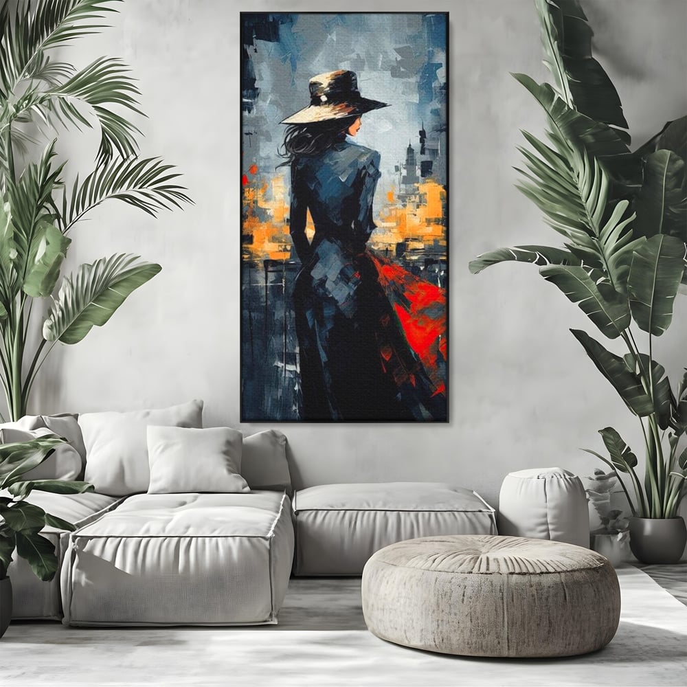 Tablou canvas cu tablou canvas cu femeie in palarie si oras, in rama de aluminiu negru, pe perete intr-un living